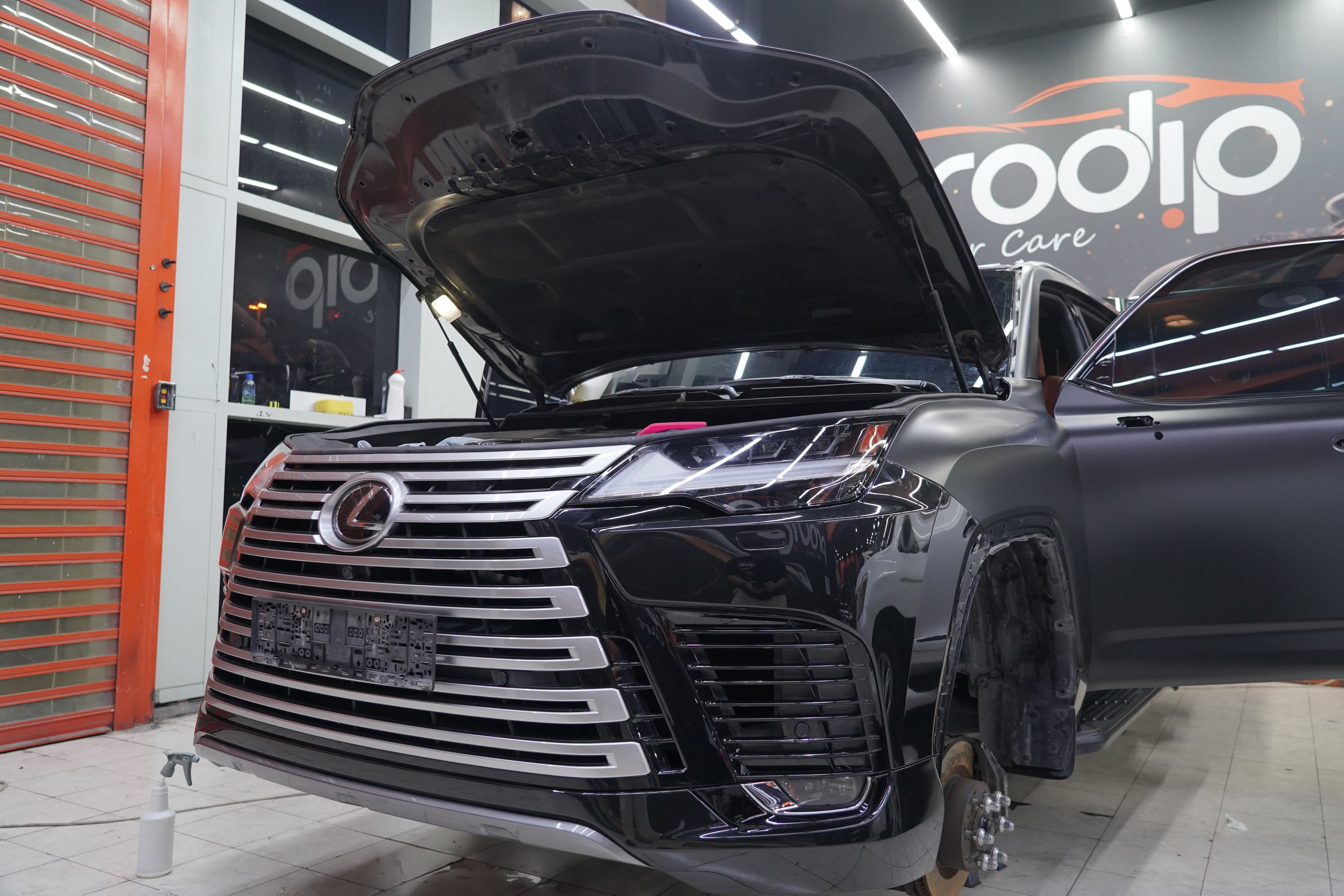 A car mid-service at Prodip Car Care, hood up